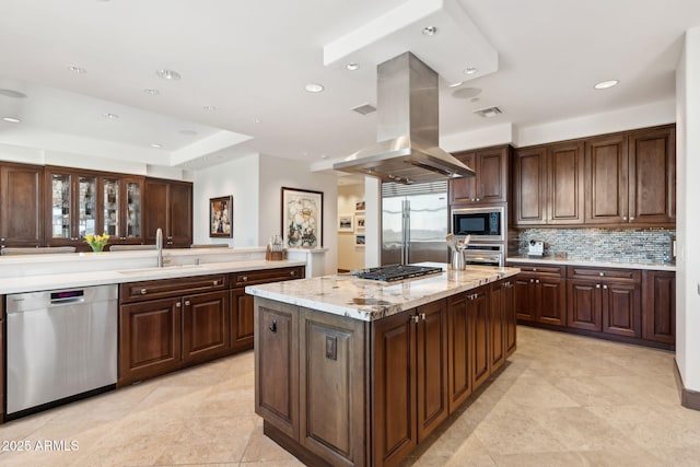 kitchen featuring built in appliances, a sink, island exhaust hood, tasteful backsplash, and recessed lighting
