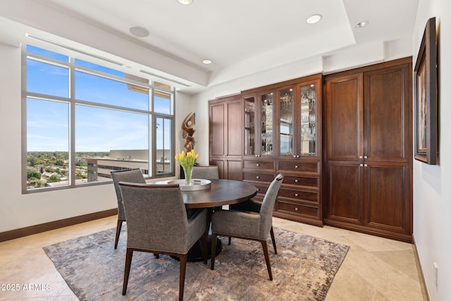 dining space with baseboards, recessed lighting, light tile patterned flooring, and a raised ceiling