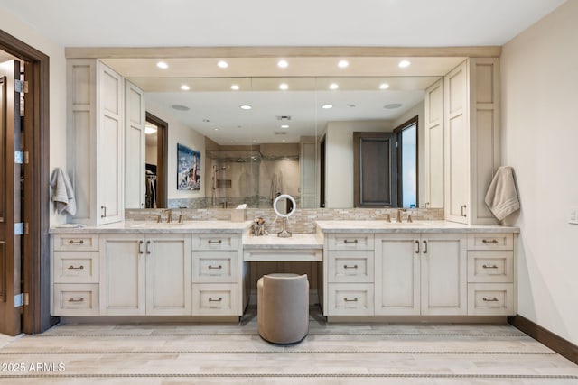 full bathroom with a stall shower, vanity, recessed lighting, wood finished floors, and baseboards
