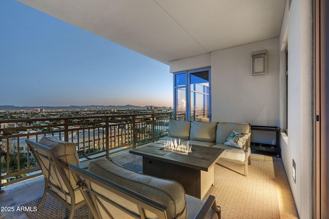 balcony with an outdoor living space with a fire pit and a mountain view