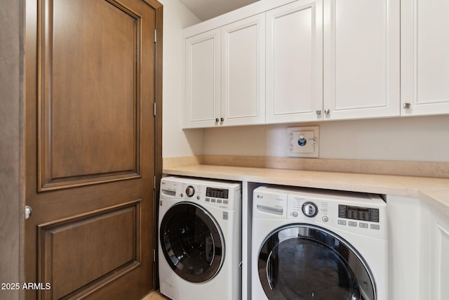 laundry room with cabinet space and washing machine and dryer