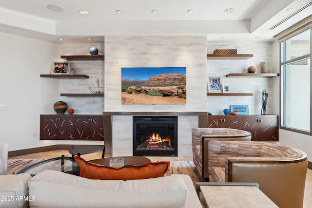 living area featuring a premium fireplace, baseboards, plenty of natural light, wood finished floors, and recessed lighting