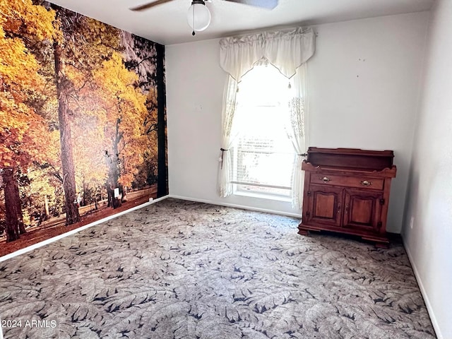 empty room with ceiling fan and light colored carpet