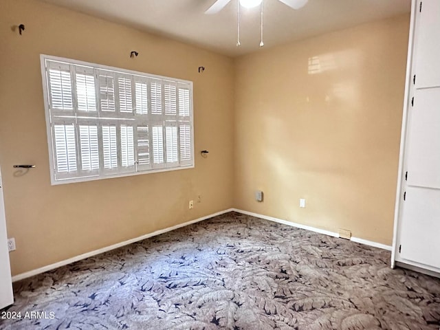 spare room featuring carpet floors and ceiling fan