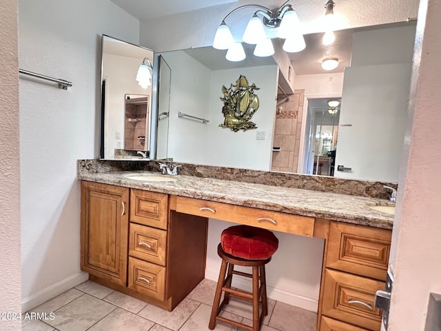 bathroom with tile patterned flooring, walk in shower, and vanity