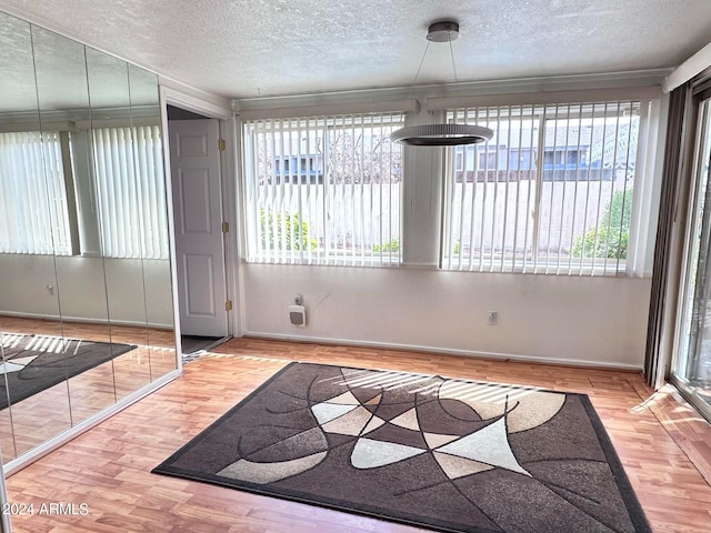 entrance foyer featuring a textured ceiling, hardwood / wood-style floors, and a wealth of natural light