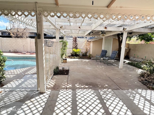 view of patio featuring a fenced in pool and a pergola