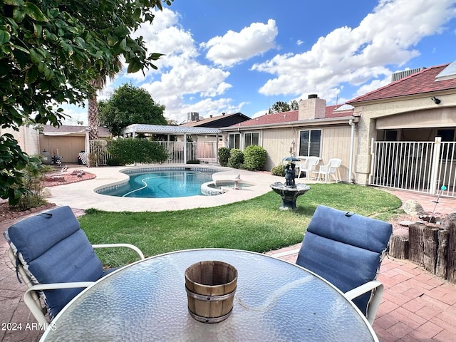 view of pool featuring a lawn and a patio