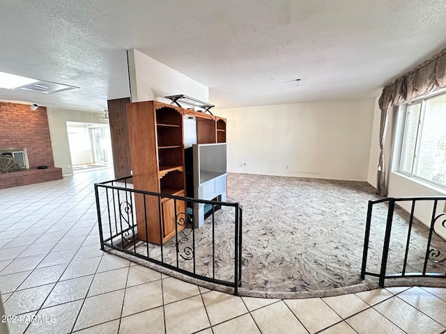 interior space featuring a textured ceiling and light tile patterned floors