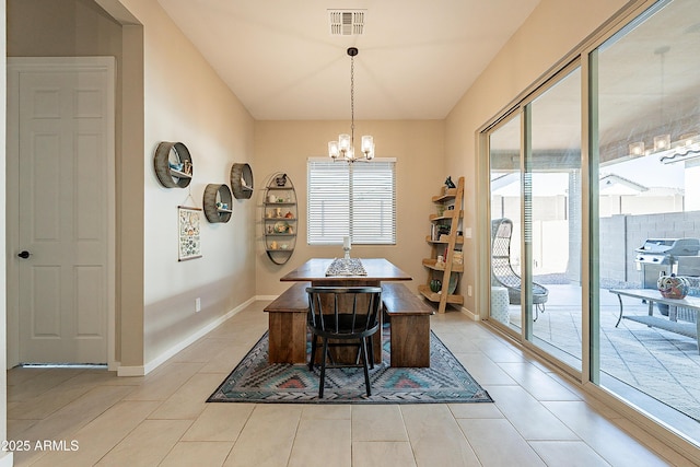 tiled dining space featuring a chandelier