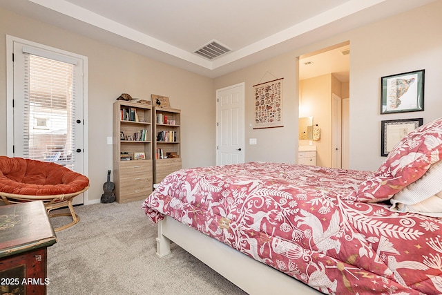 bedroom with carpet floors and connected bathroom