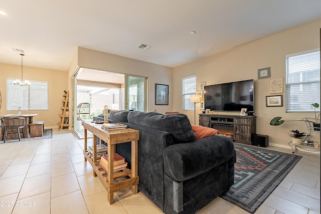 living room featuring light tile patterned floors and a notable chandelier