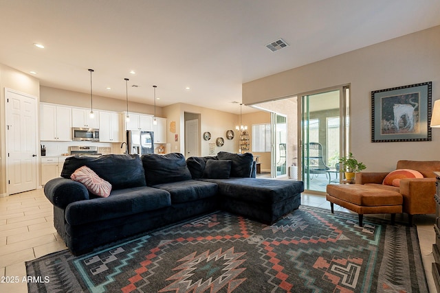 living room with sink, tile patterned floors, and an inviting chandelier