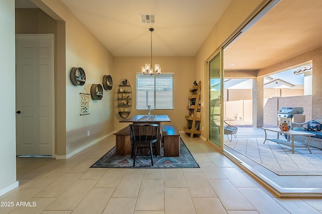 tiled dining room featuring a notable chandelier