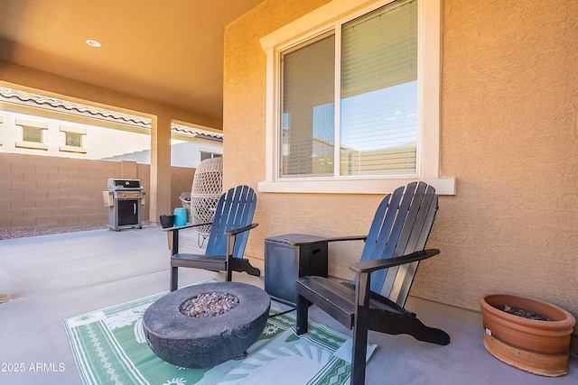 view of patio featuring an outdoor fire pit and area for grilling