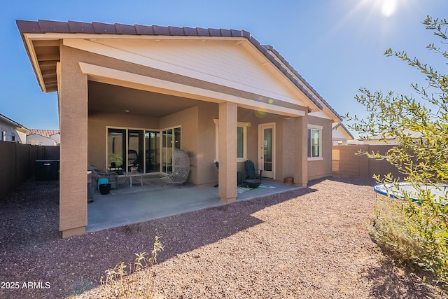 back of property featuring central AC and a patio