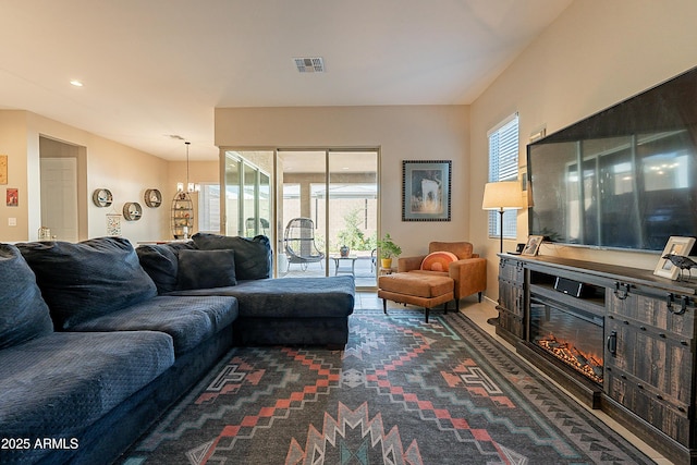 living room featuring a chandelier and a healthy amount of sunlight