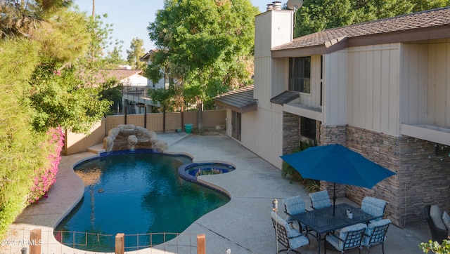 view of pool with a patio and an in ground hot tub