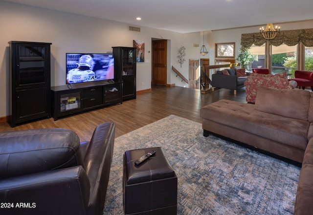 living room with a notable chandelier and hardwood / wood-style flooring