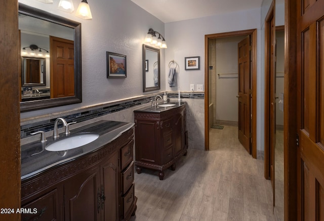 bathroom with vanity, tile walls, and hardwood / wood-style floors