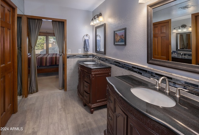 bathroom featuring vanity, tile walls, and hardwood / wood-style flooring