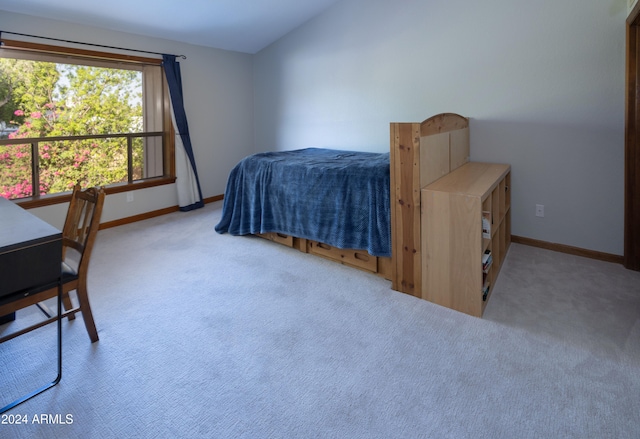 carpeted bedroom with vaulted ceiling