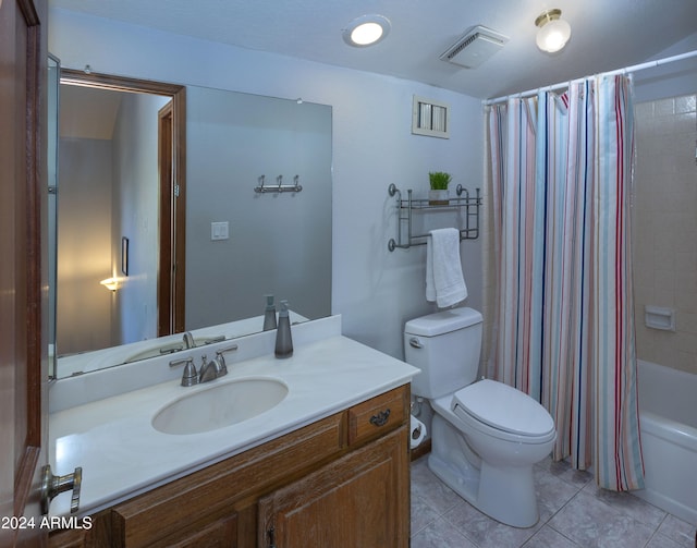 full bathroom featuring toilet, tile patterned floors, vanity, and shower / tub combo with curtain