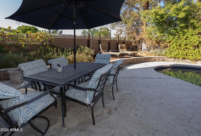 view of patio with a fenced in pool