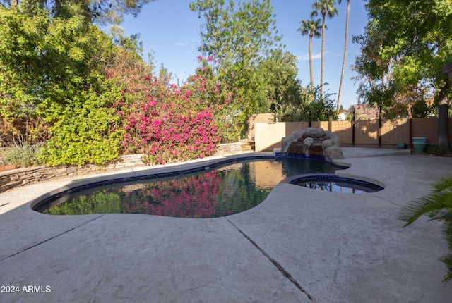 view of pool with a patio area and an in ground hot tub