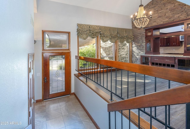 tiled entrance foyer featuring a chandelier