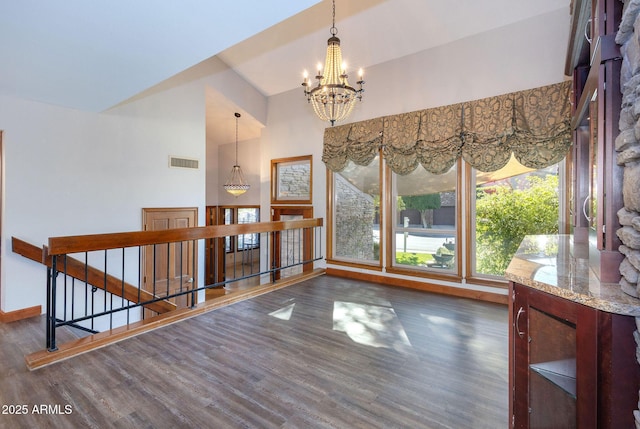 interior space with dark hardwood / wood-style flooring and a notable chandelier