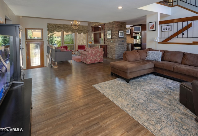 living room with dark wood-type flooring and a notable chandelier