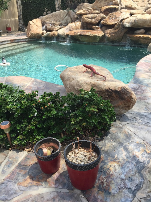 view of pool with pool water feature