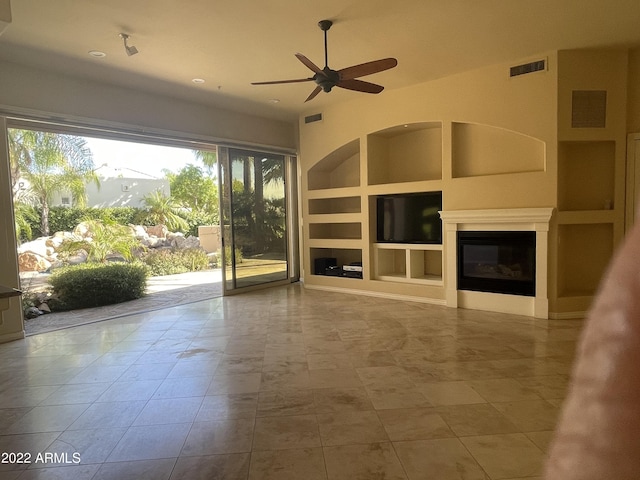 unfurnished living room featuring tile patterned floors, ceiling fan, and built in features