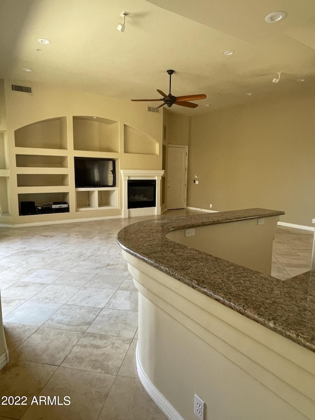 kitchen featuring light tile patterned floors, built in features, and ceiling fan