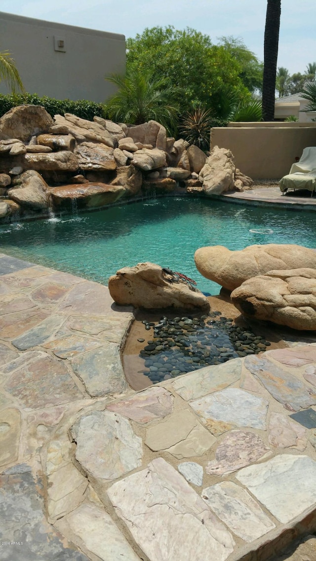 view of pool featuring pool water feature