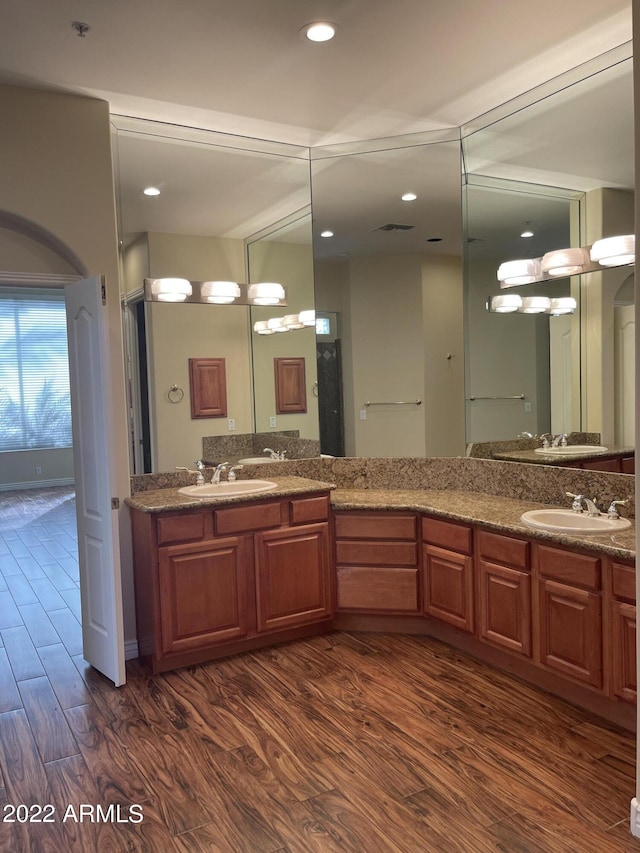 bathroom with hardwood / wood-style flooring and vanity
