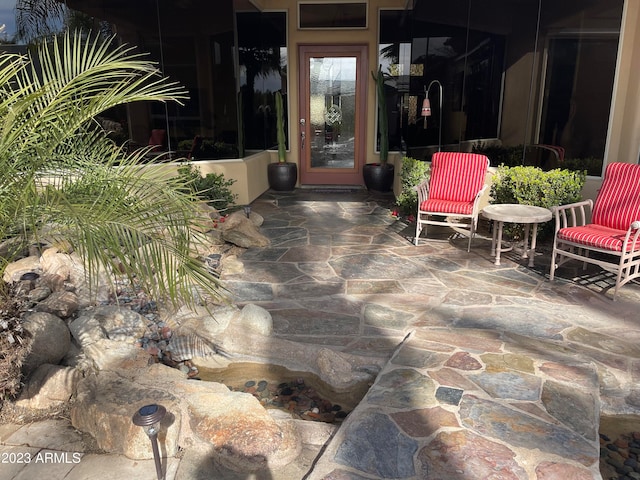 view of exterior entry featuring a patio area