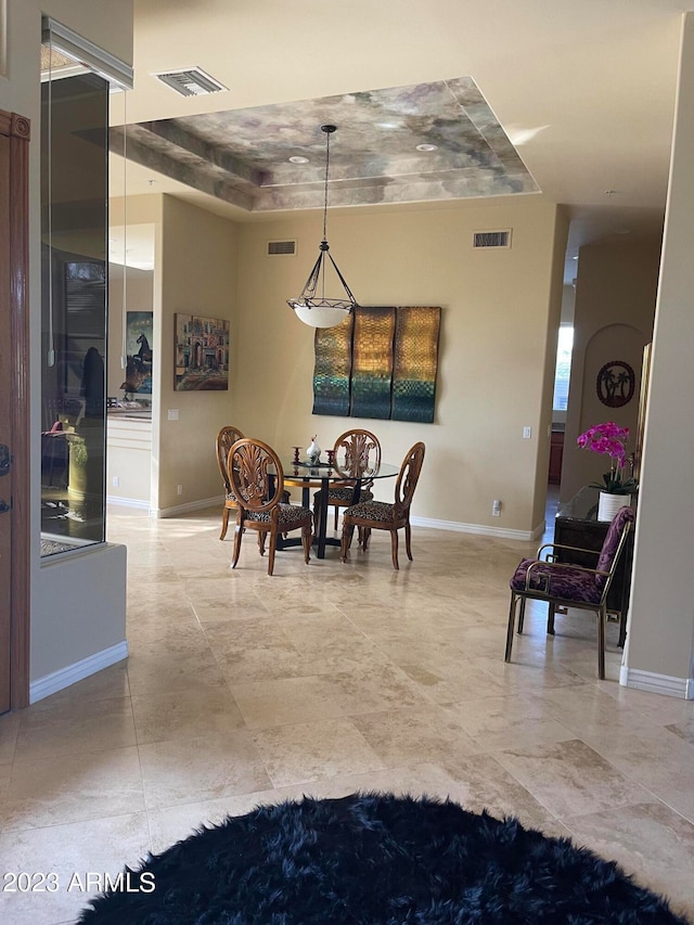 dining room featuring a raised ceiling