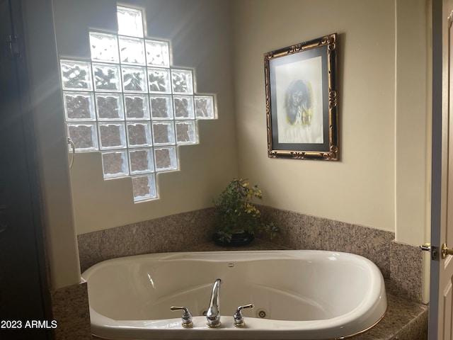 bathroom with a tub to relax in