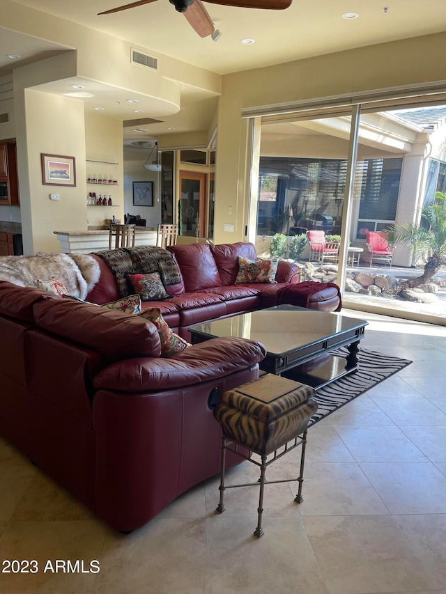 living room featuring light tile patterned floors and ceiling fan