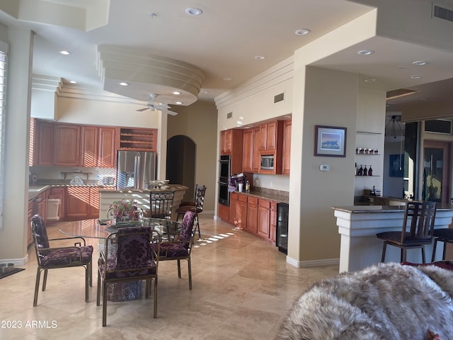 dining area featuring ceiling fan and beverage cooler