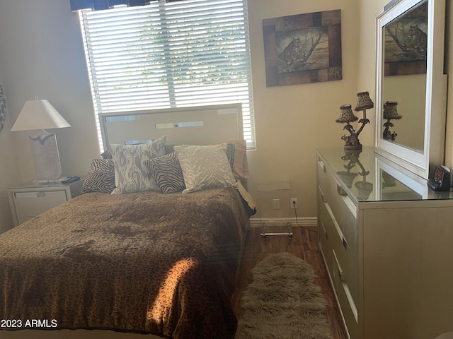 bedroom with dark wood-type flooring