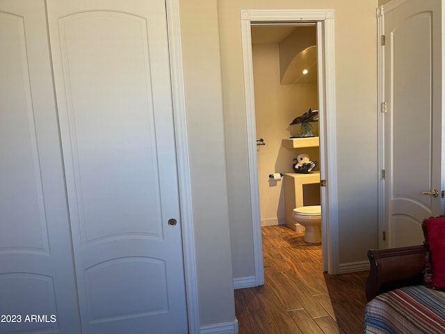 bathroom featuring hardwood / wood-style flooring and toilet