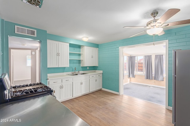 kitchen featuring white cabinetry, light hardwood / wood-style flooring, stainless steel appliances, and sink