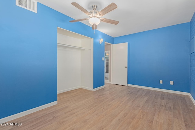 unfurnished bedroom featuring light hardwood / wood-style flooring, a closet, and ceiling fan