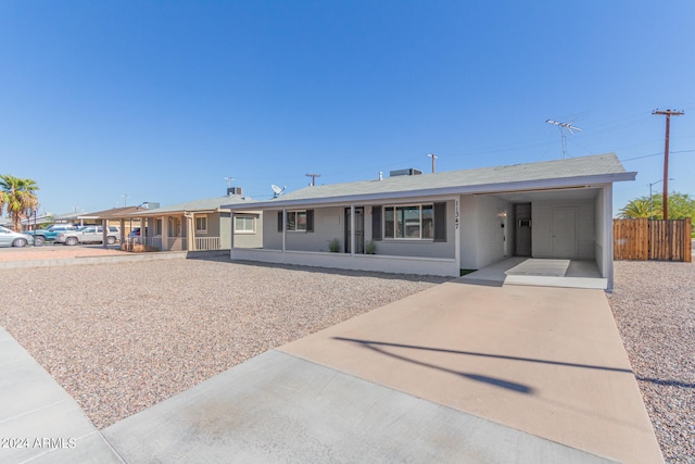 ranch-style home featuring a carport