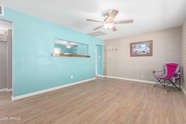 unfurnished room with ceiling fan and light hardwood / wood-style flooring