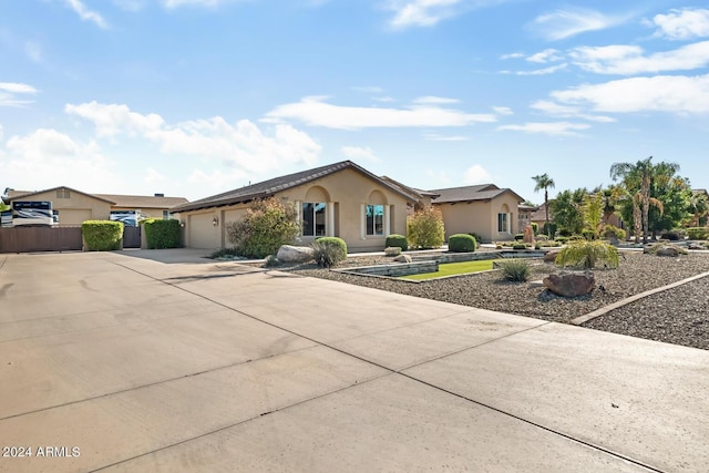 ranch-style house featuring a garage, stucco siding, and concrete driveway