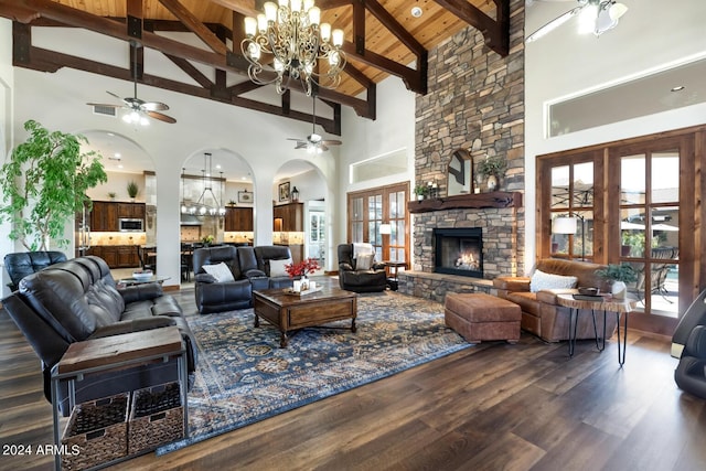living room featuring arched walkways, high vaulted ceiling, and ceiling fan with notable chandelier